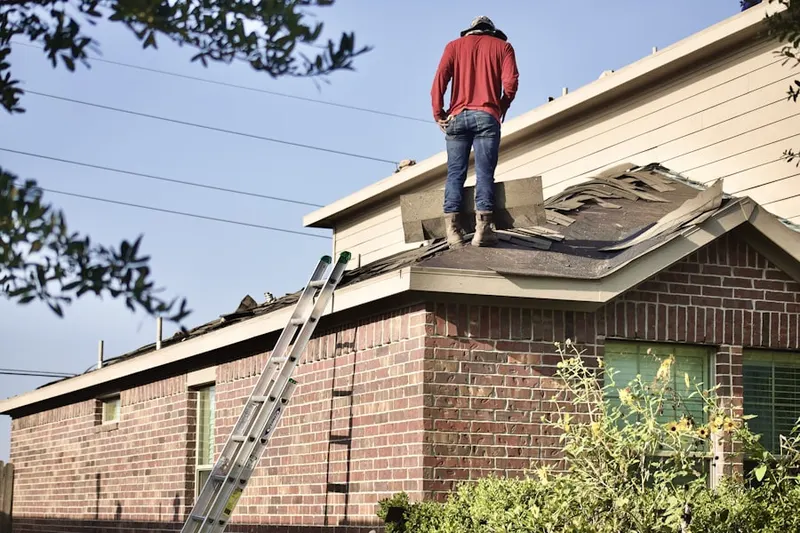 Professional roofer working on a residential roof in Lakebelle
